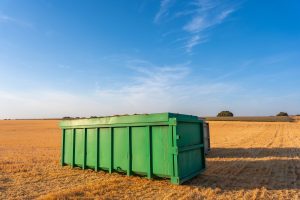 	
A large green dumpster sits in the middle of a dry, harvested field under a clear blue sky, ready for Dumpster Rental in Sunnyvale.